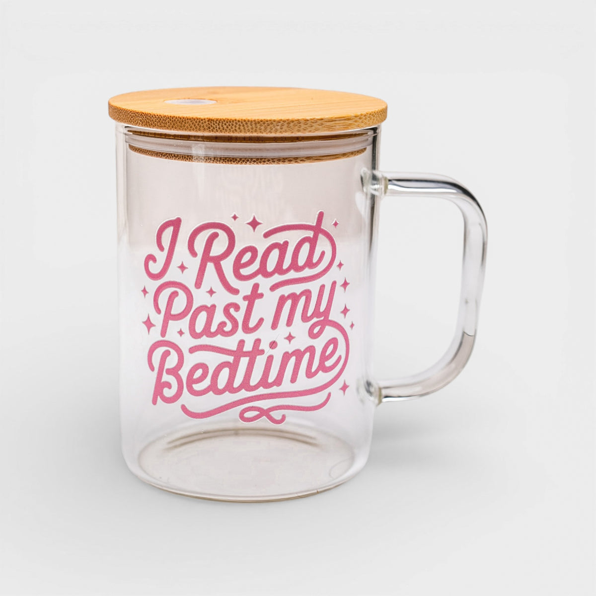 Glass mug with bamboo lid and pink text on a white background