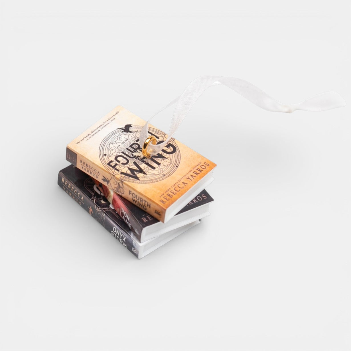 Mini Fourth Wing book stack ornament against a white background