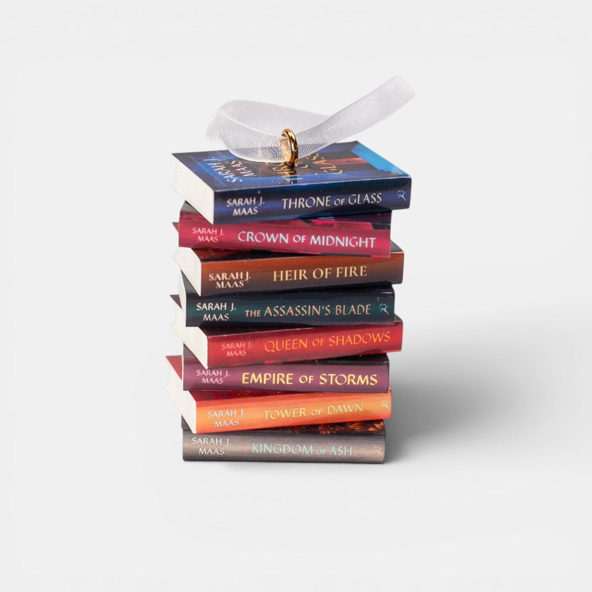 Ornament with a stack of mini Throne of Glass books on a white background