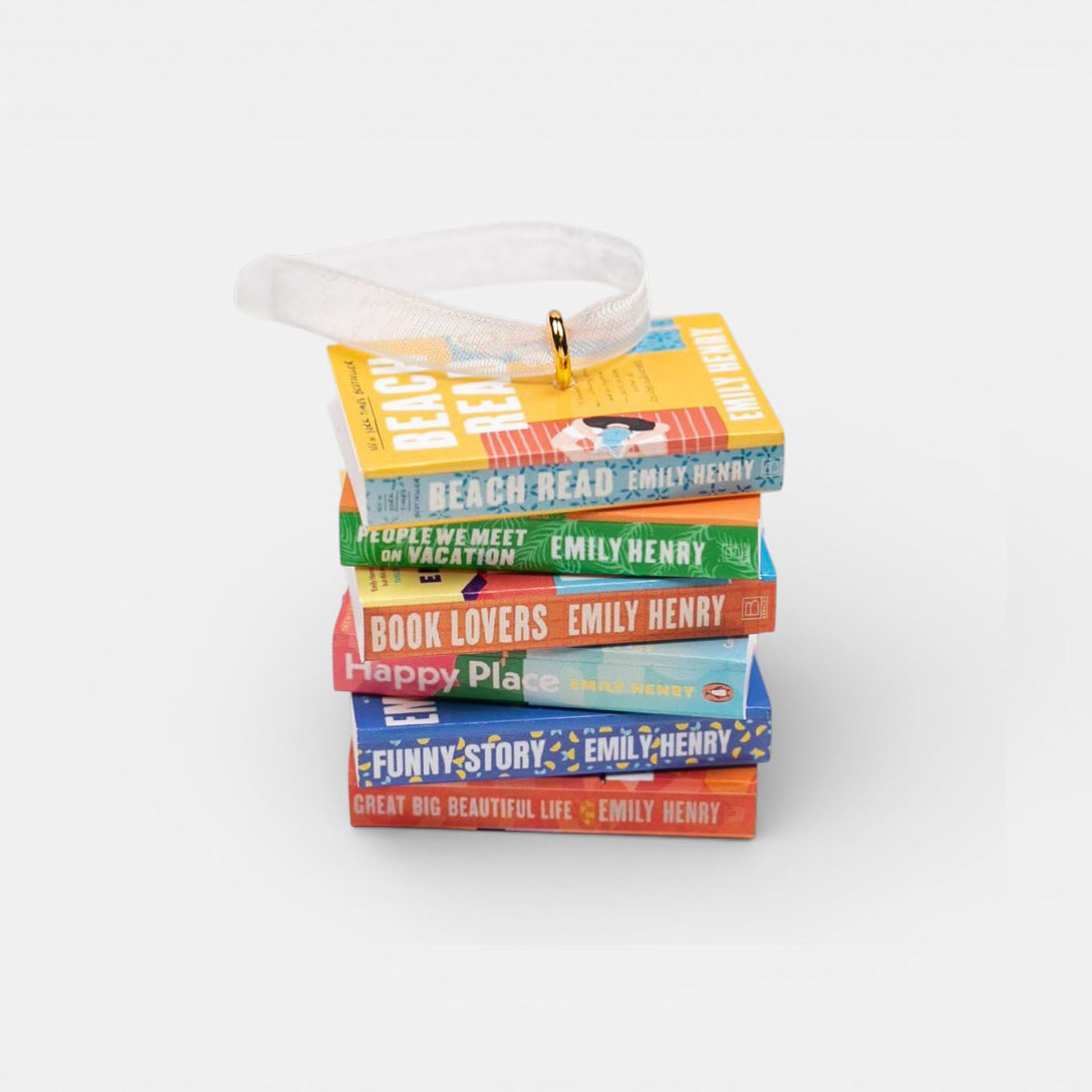 Ornament featuring a mini stack of Emily Henry books with a decorative ribbon on a white background