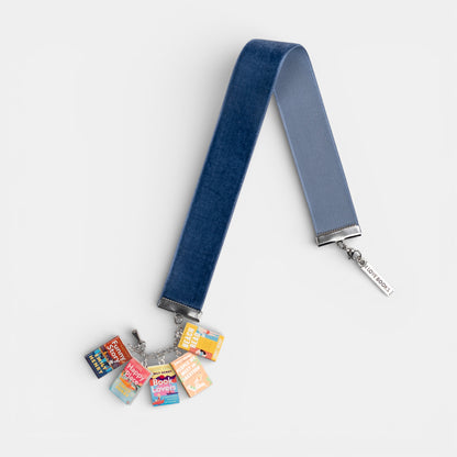 Blue, velvet ribbon bookmark with Emily Henry mini book charms on a white background