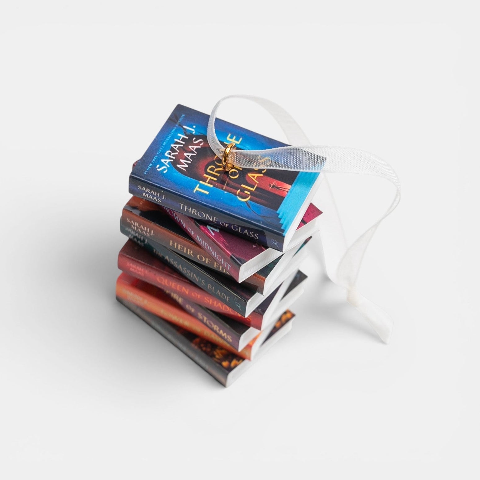 Ornament with a stack of mini Throne of Glass books on a white background