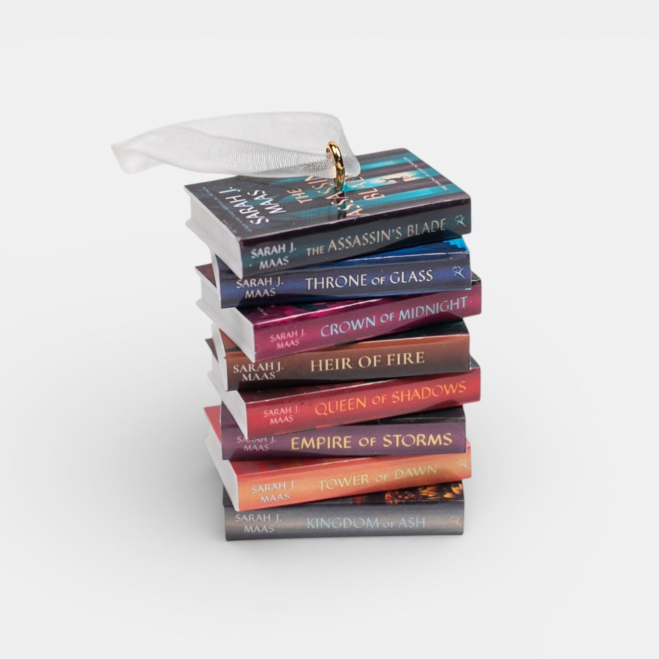 Ornament featuring mini Throne of Glass stack of books with colorful covers on a white background