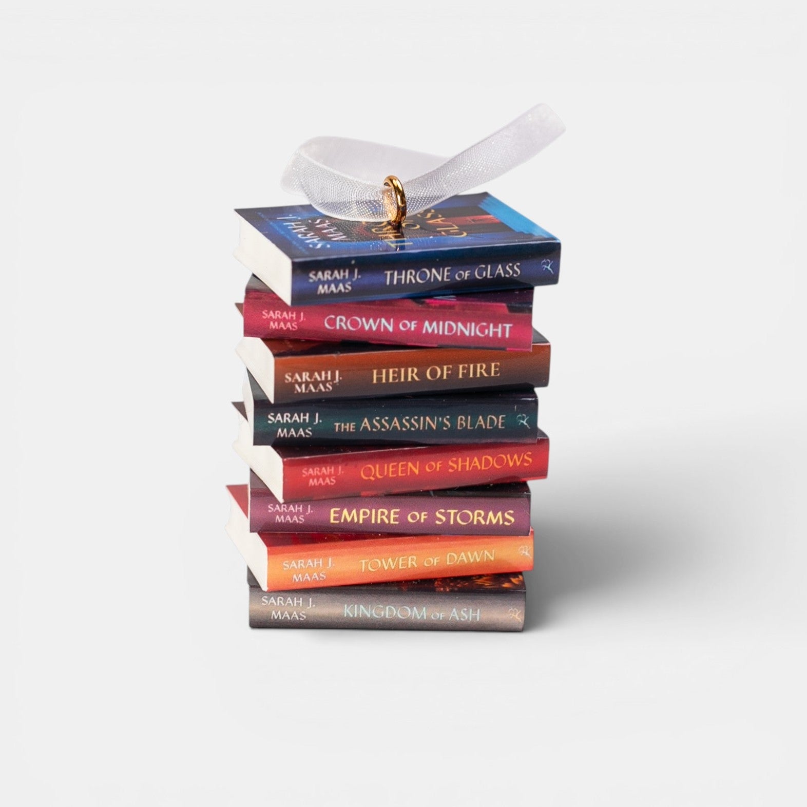 Ornament with a stack of mini Throne of Glass books on a white background