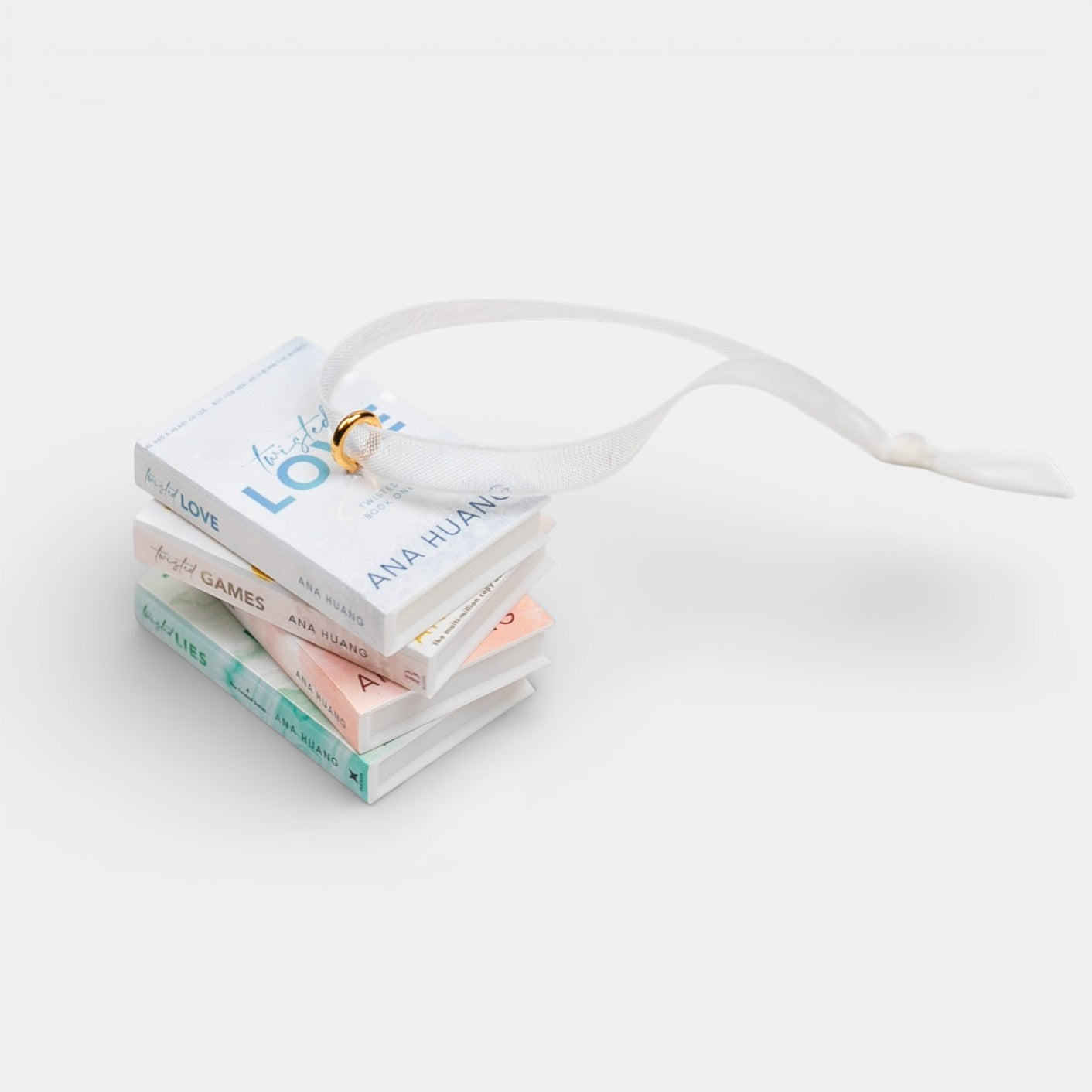 Ornament featuring a mini stack of Ana Huang books with visible titles and author name on a light gray background