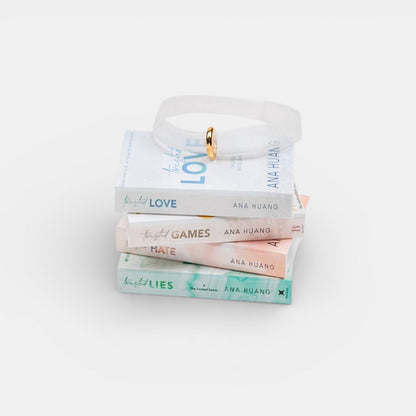 Ornament featuring a mini stack of Ana Huang books with visible titles and author name on a light gray background