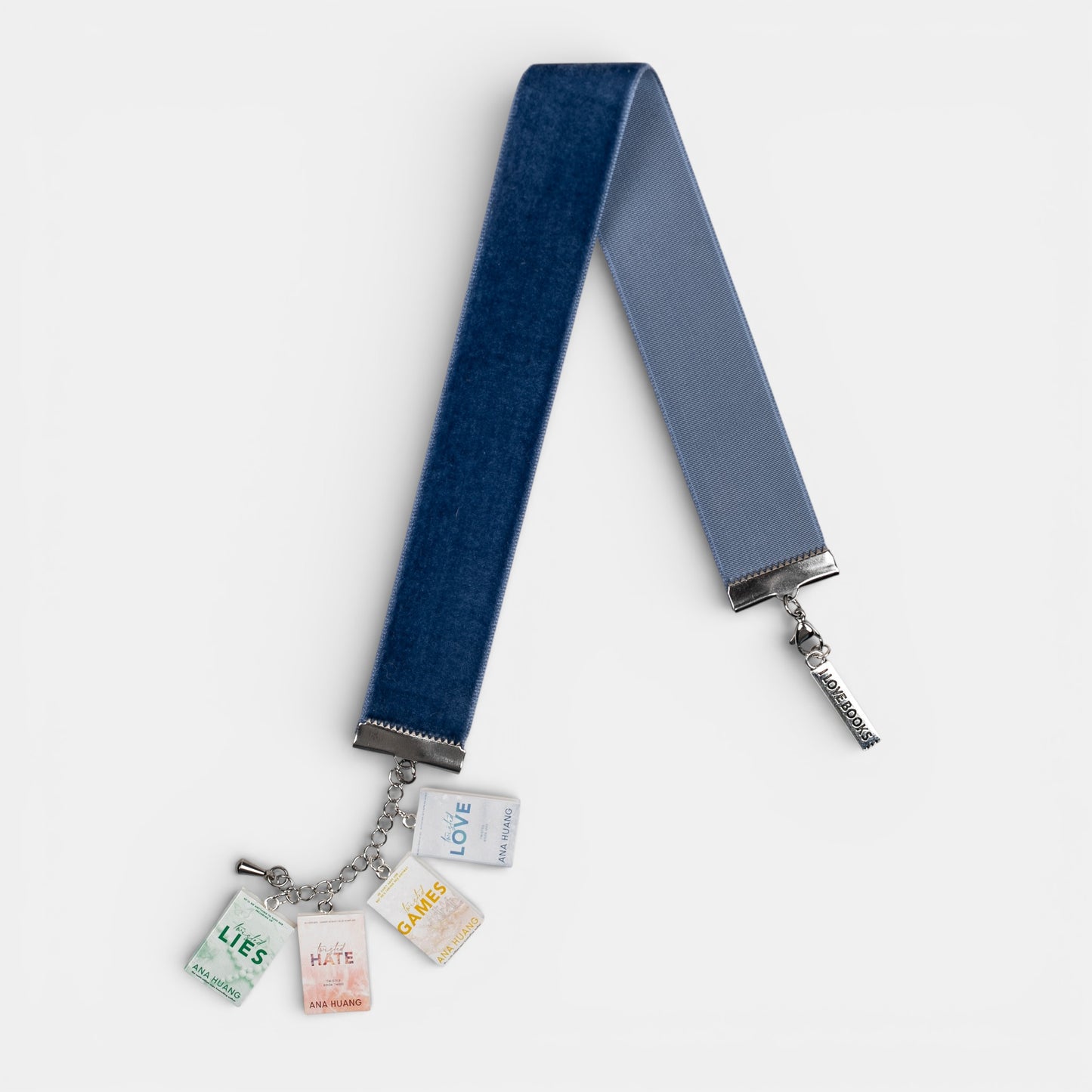 Blue, velvet ribbon with mini book charms of Ana Huang's Twisted series on a white background