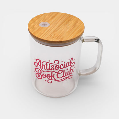 Clear glass mug with bamboo lid and 'Antisocial Book Club' text in pink on a white background