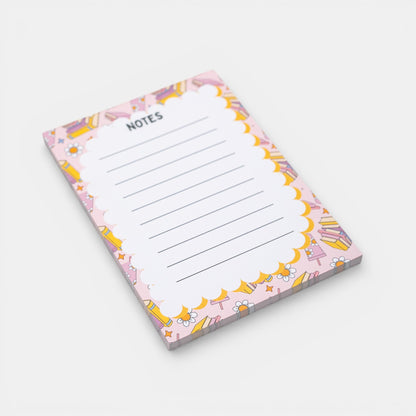 Notepad with a colorful border featuring books on a white background