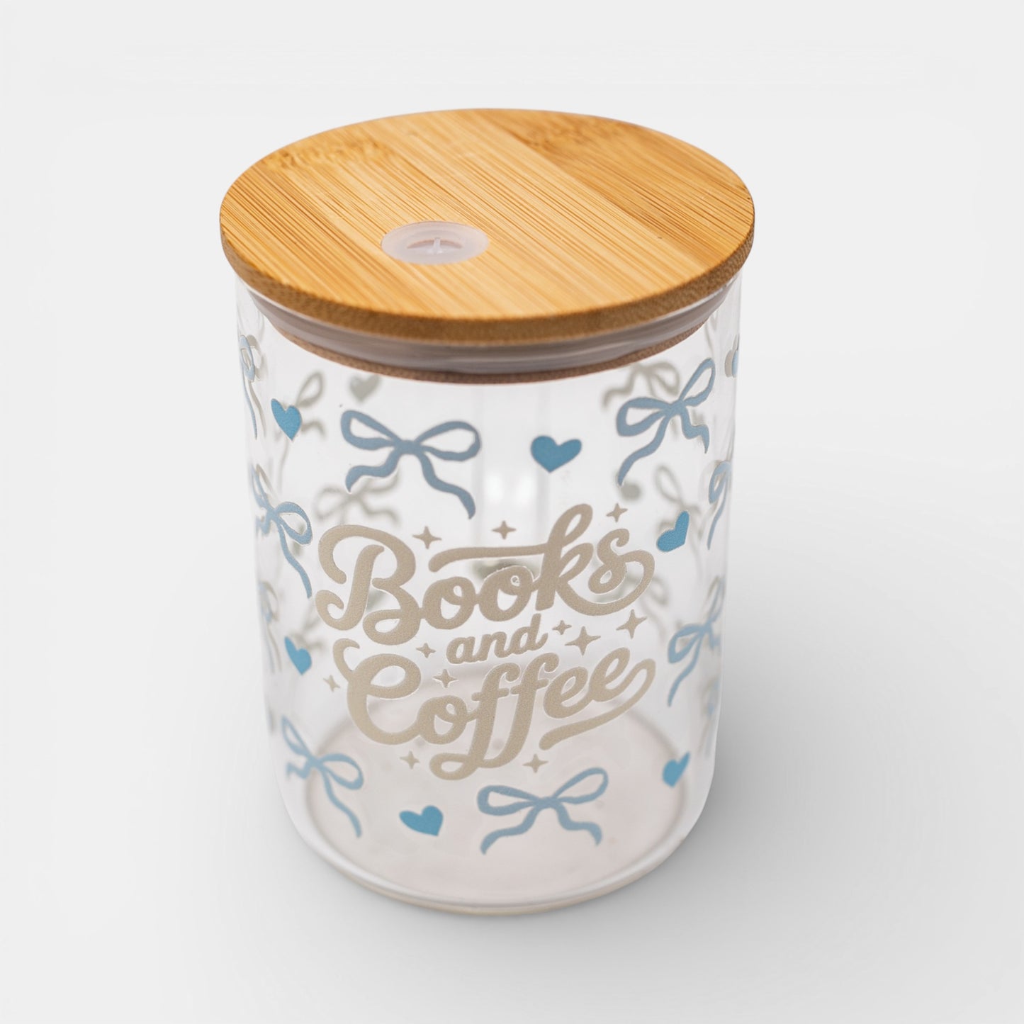 Glass mug with bamboo lid featuring 'Books and Coffee' text and bows on a white background