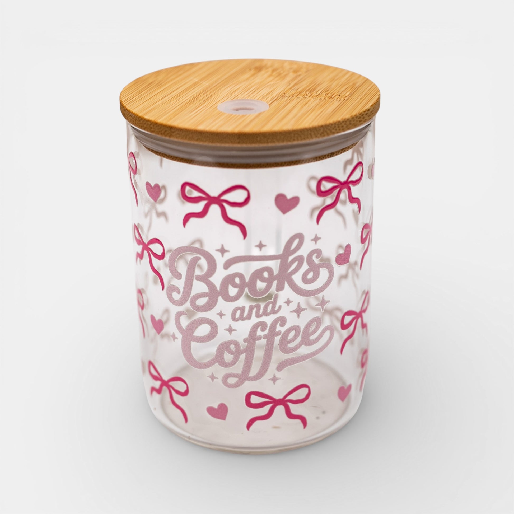 Glass jar with bamboo lid featuring 'Books and Coffee' text and pink bows on a white background