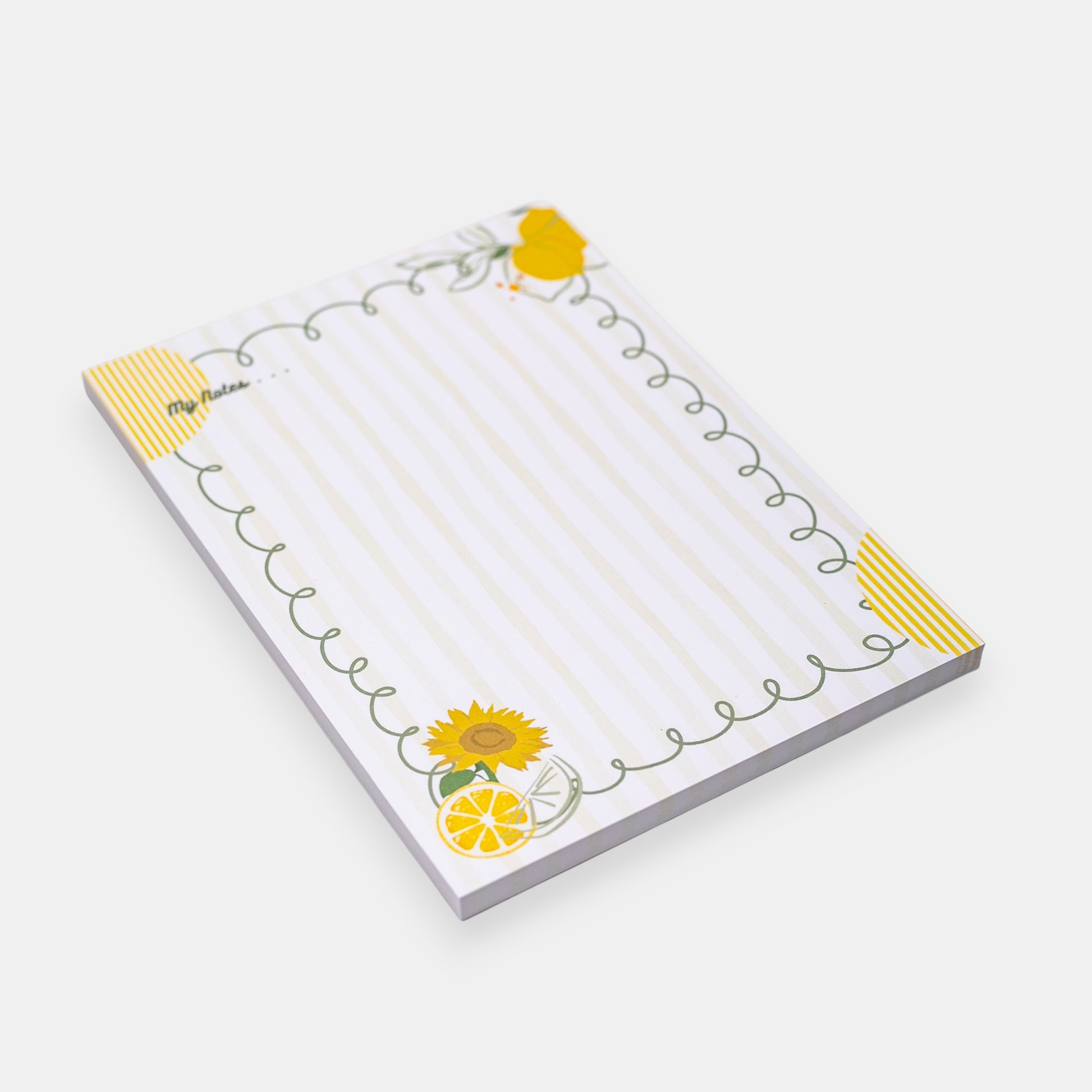 Notepad with sunflower and lemon designs on a white background