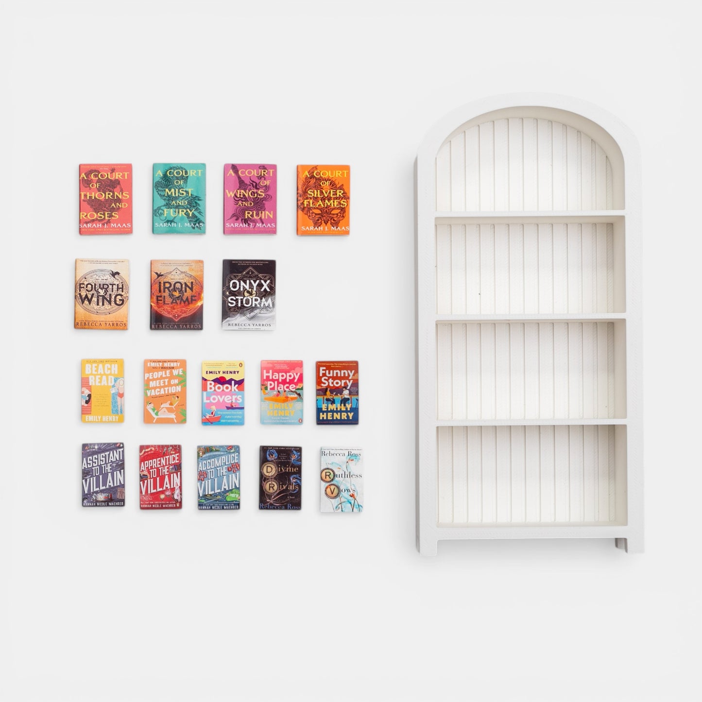 Miniature white bookshelf with books on a white background