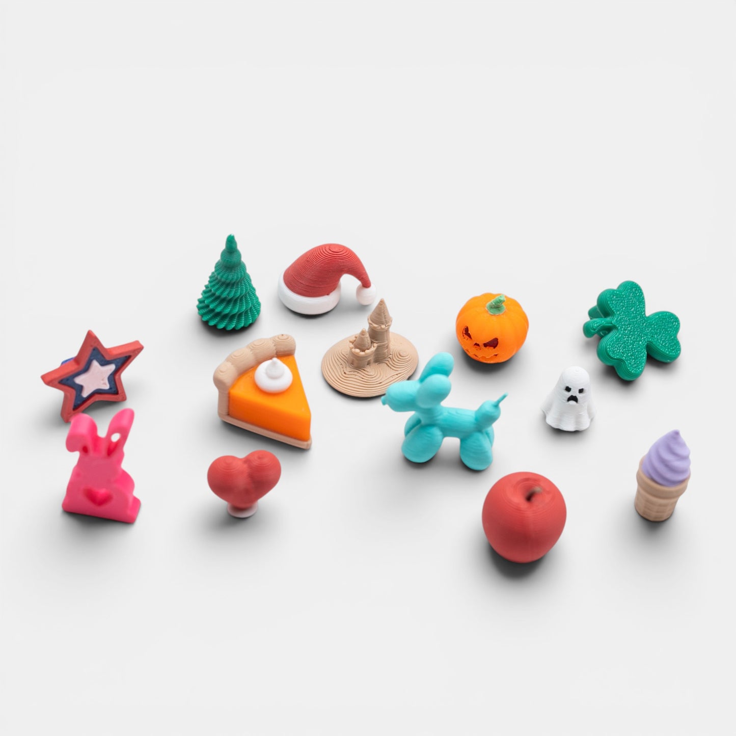 Assorted colorful holiday trinkets on a white background