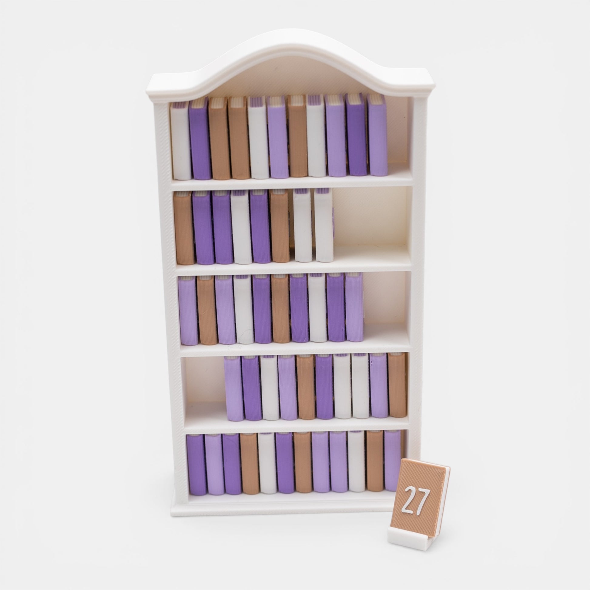 Mini white bookshelf with numbered mini books to track reading progress on a white background