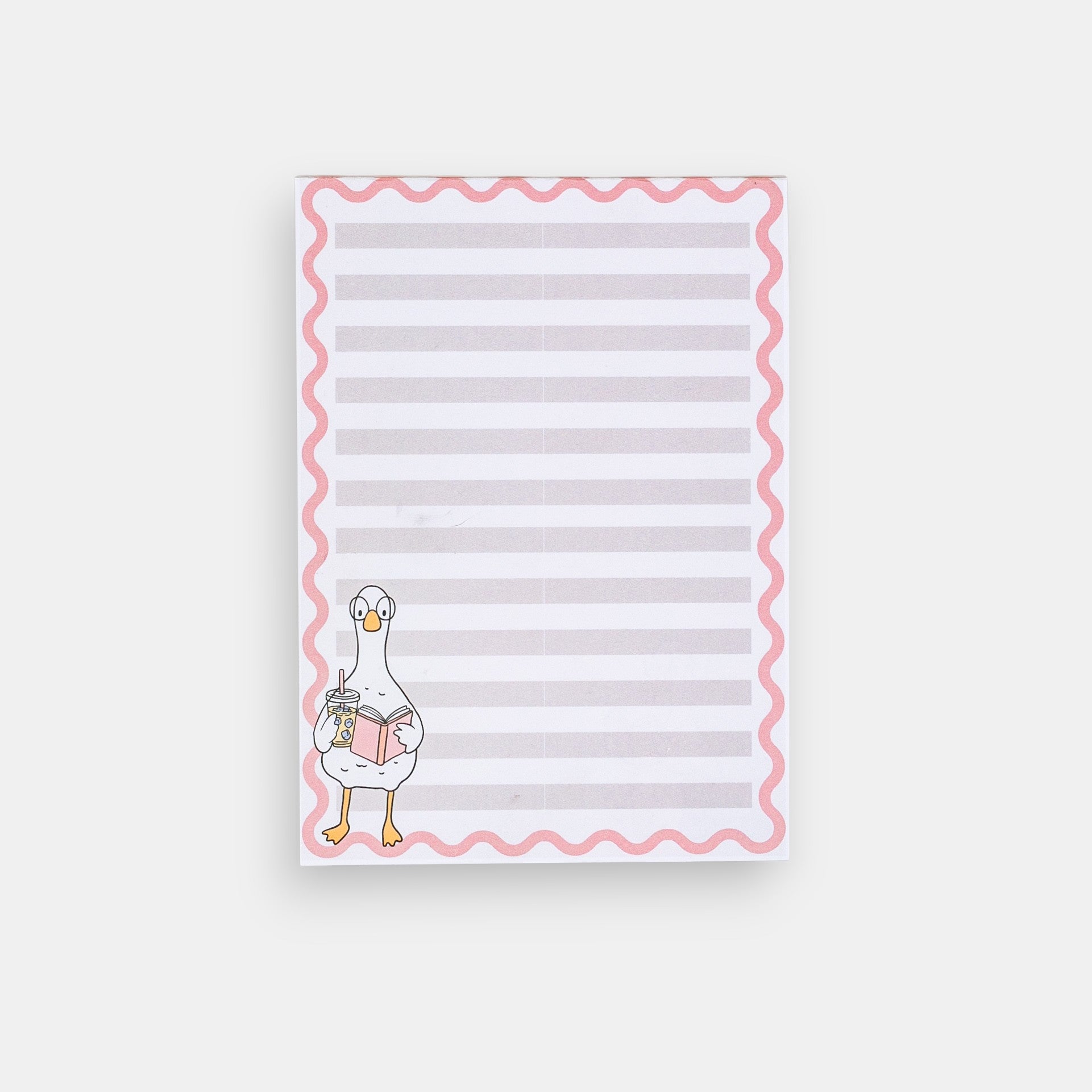 Notepad with a cartoon duck holding a book on a white background