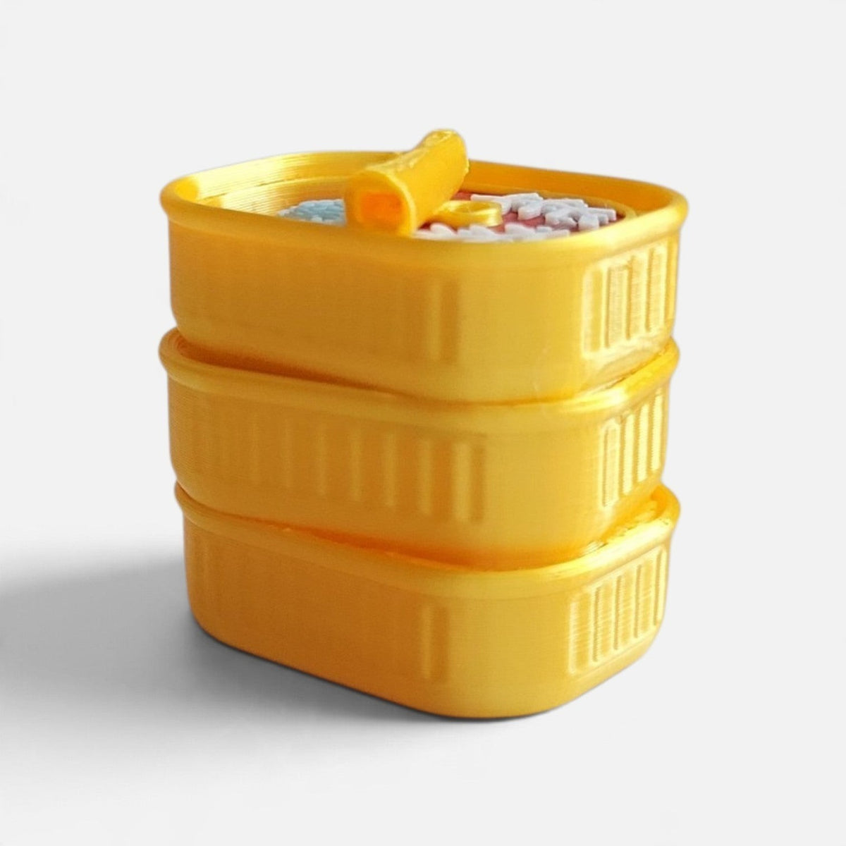 The Salty Cat Co yellow 3D-printed sardines fidget clicker toy shaped like a small stack of sardine tins